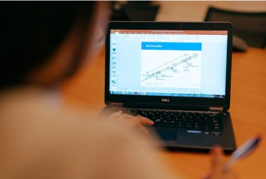 A person working in front of a laptop.<image 3>