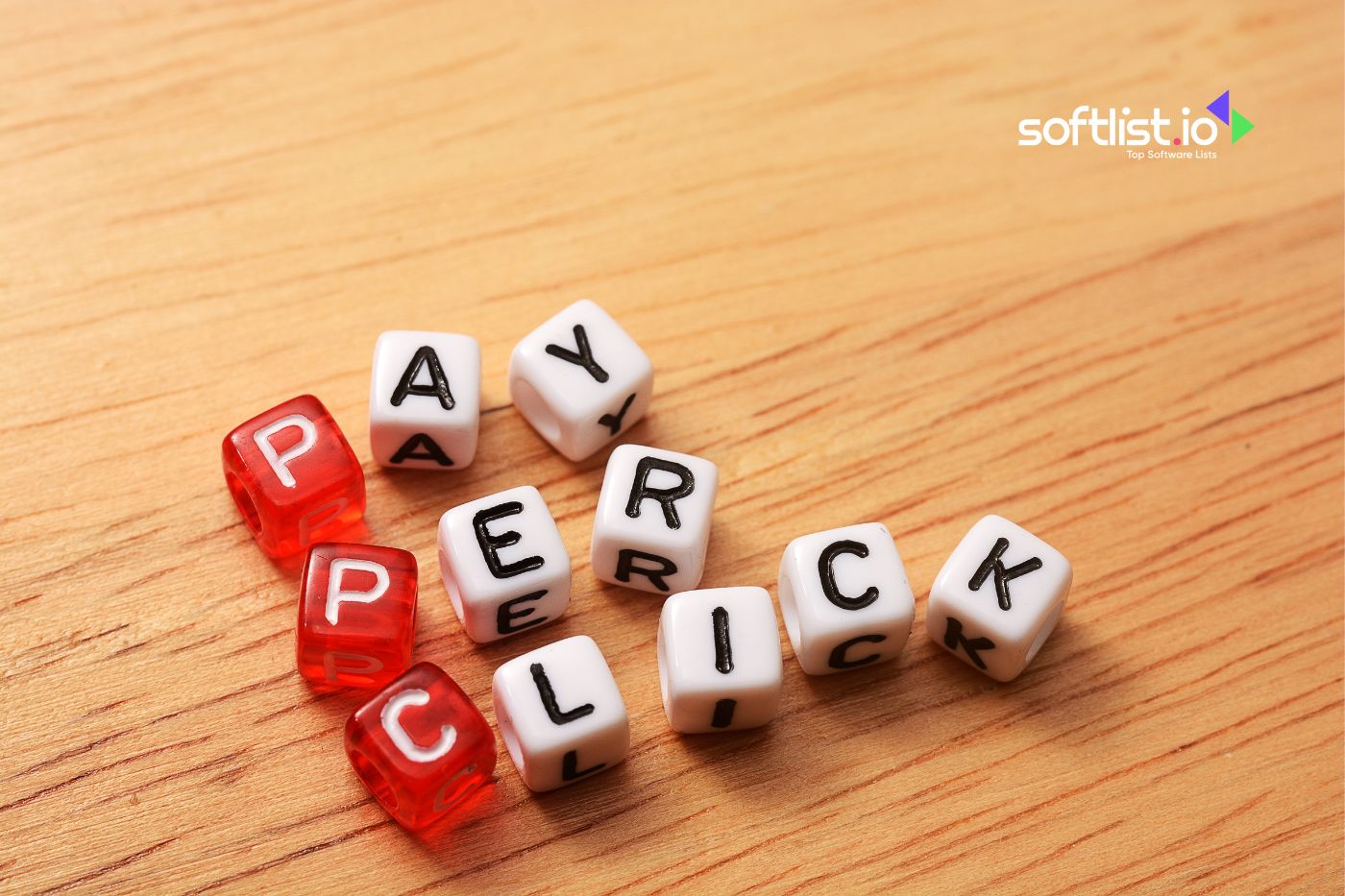 Dice spelling 'PAY PER CLICK' on wooden surface