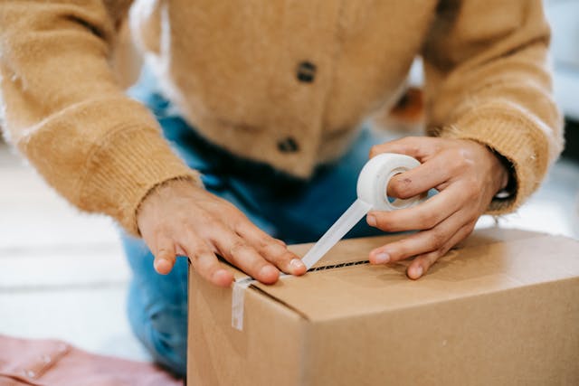 A woman preparing a parcel