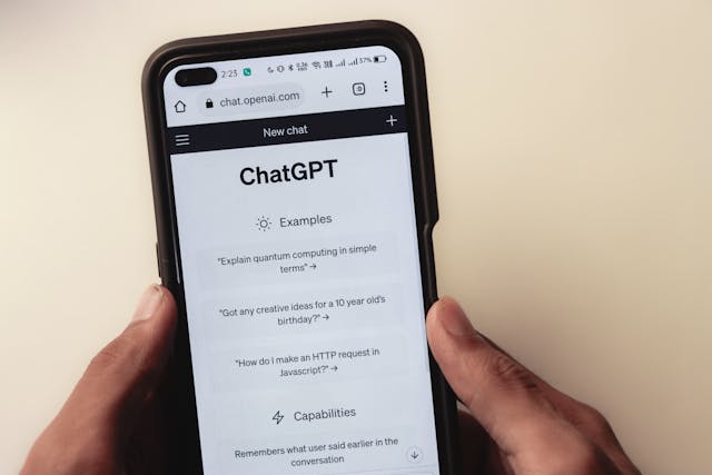Webpage of ChatGPT, a prototype AI chatbot, is seen on the website of OpenAI, on a smartphone. Examples, capabilities, and limitations are shown
