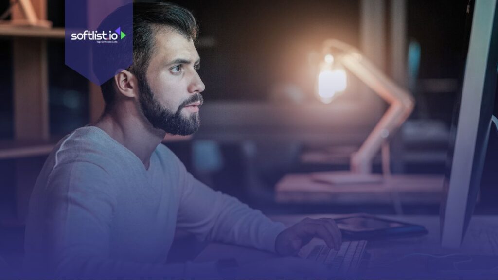 A man looking serious looking at his laptop