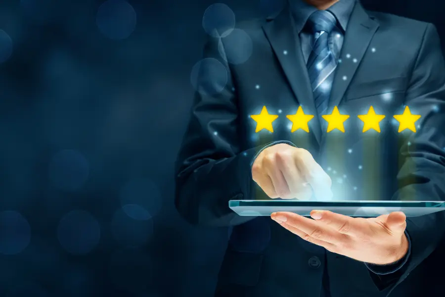 Evaluating eLearning Platforms: Discover the 12 Criteria 7 a person holding a tablet with five stars