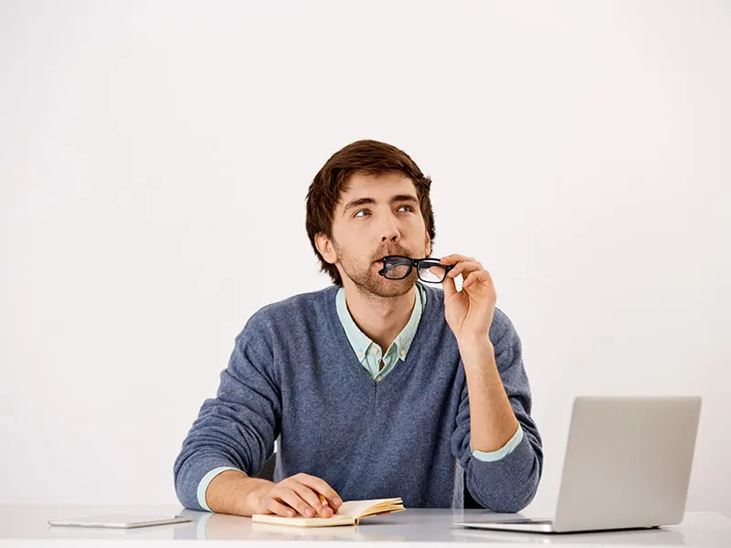 a man biting its eyeglass