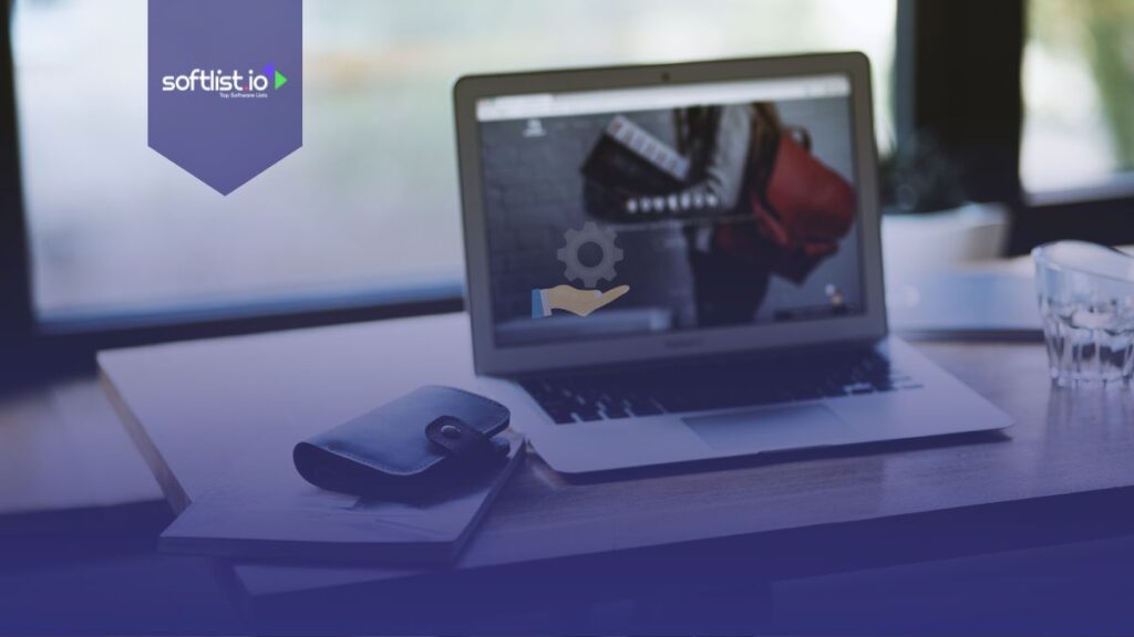Laptop with wallet and notebook on the table.
