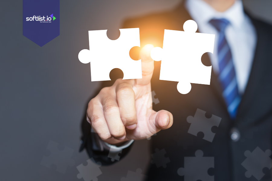 Businessman in a suit connecting two puzzle pieces, symbolizing strategic alignment and partnership in mergers and acquisitions.