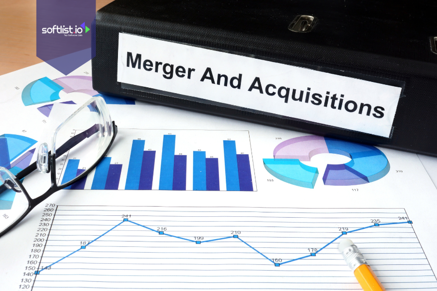 Documents and graphs labeled Mergers and Acquisitions beside a binder, illustrating financial analysis and strategic planning in corporate M&A activities.