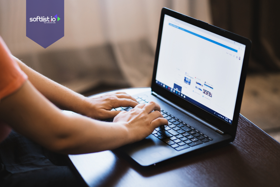 Person browsing websites on a laptop, representing research for niche website valuation.