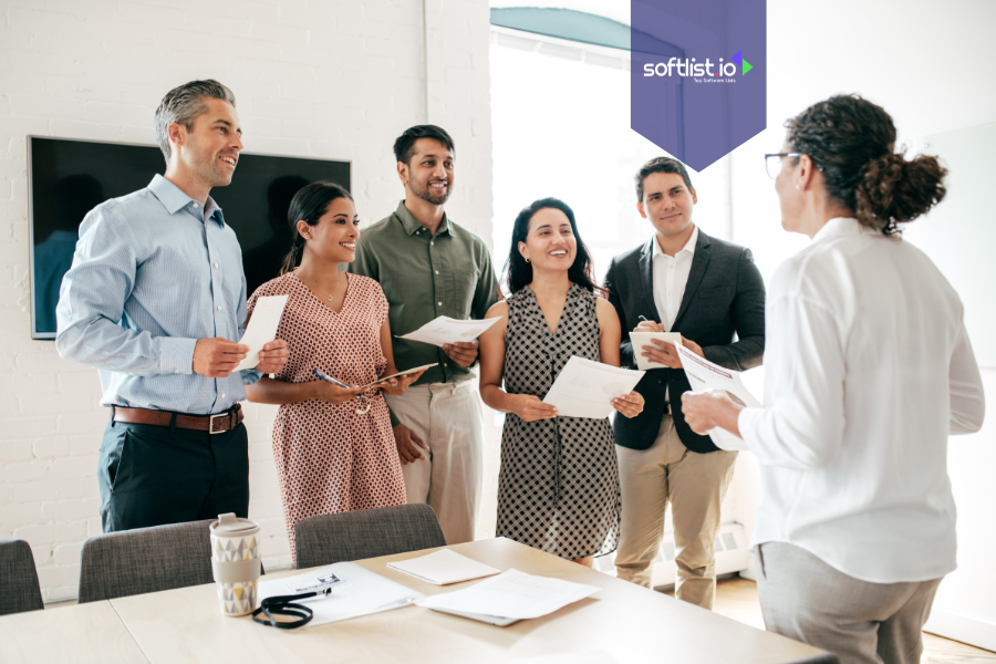 Team of professionals standing and smiling during a collaborative meeting, representing community-driven business valuation through shared feedback and interaction.